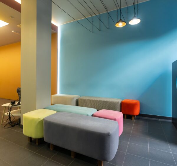 The Waiting room of a modern dental clinic with colored sofas