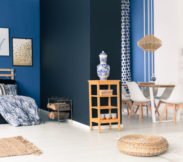 Stylish white and blue studio with wooden furniture